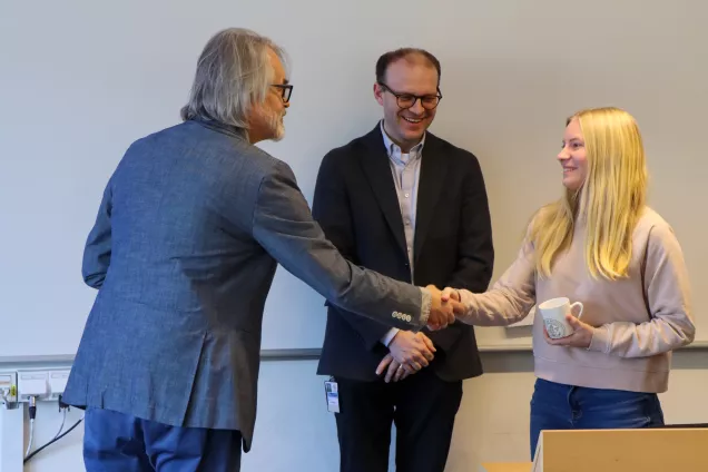 Student getting handshake from head of department during graduation